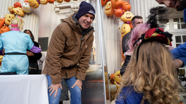 Governor Beshear talking to a trick or treater during Halloween 2023.